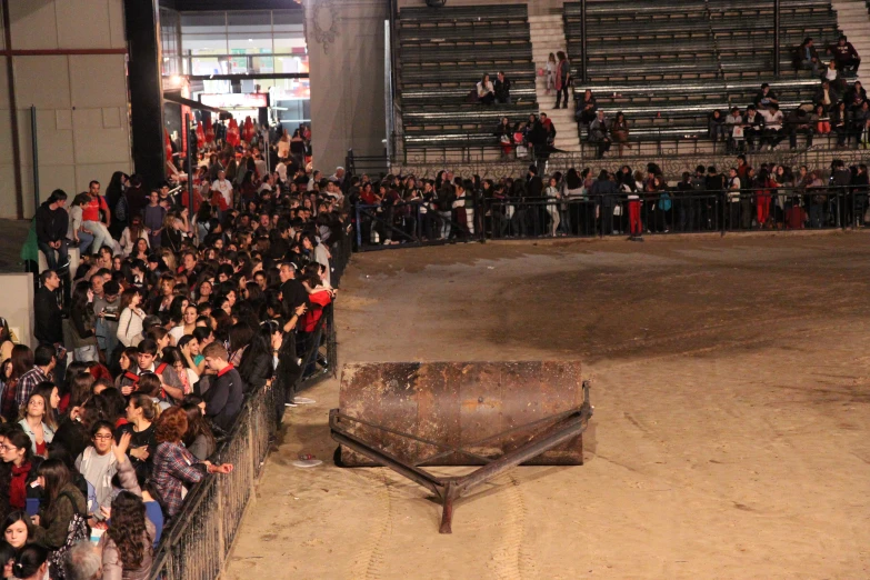 people sitting and standing around the edge of a stadium