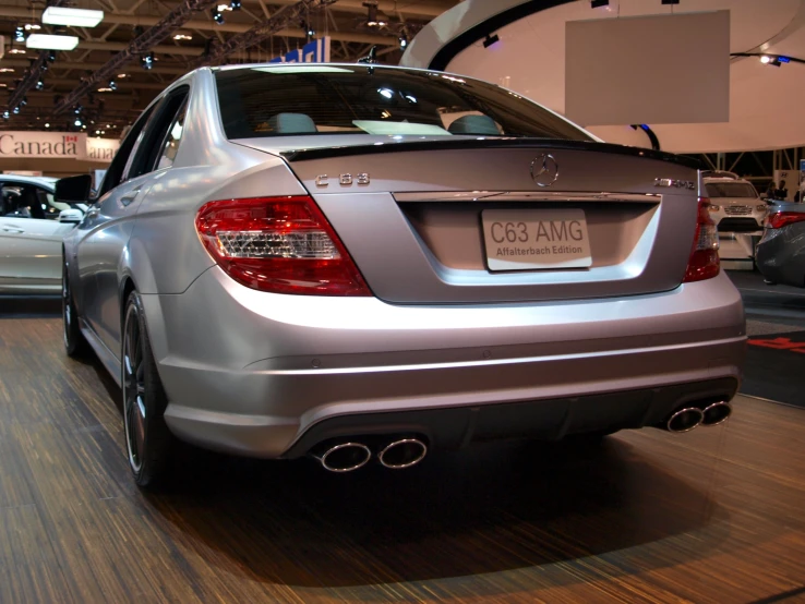 a silver mercedes car is on display inside a building