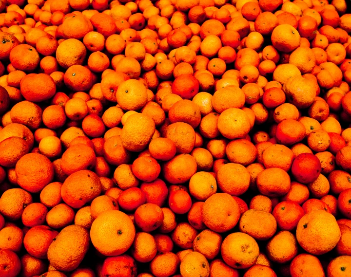 a bunch of oranges stacked up with each other