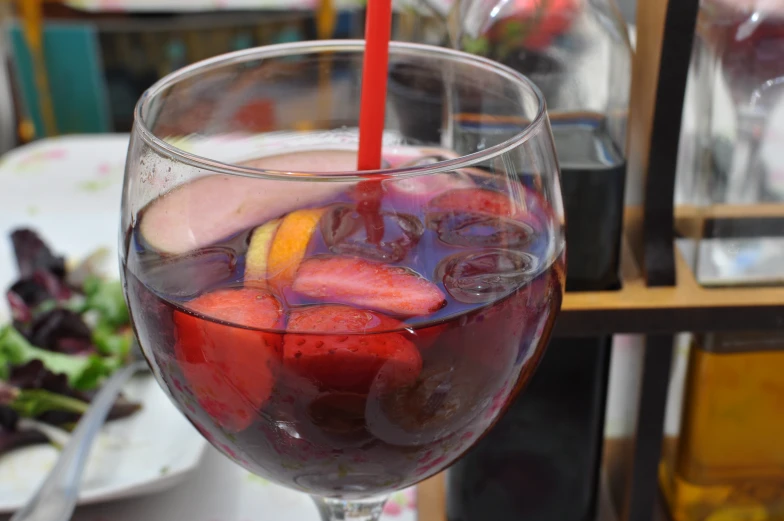 a close up of a beverage with various fruit on it