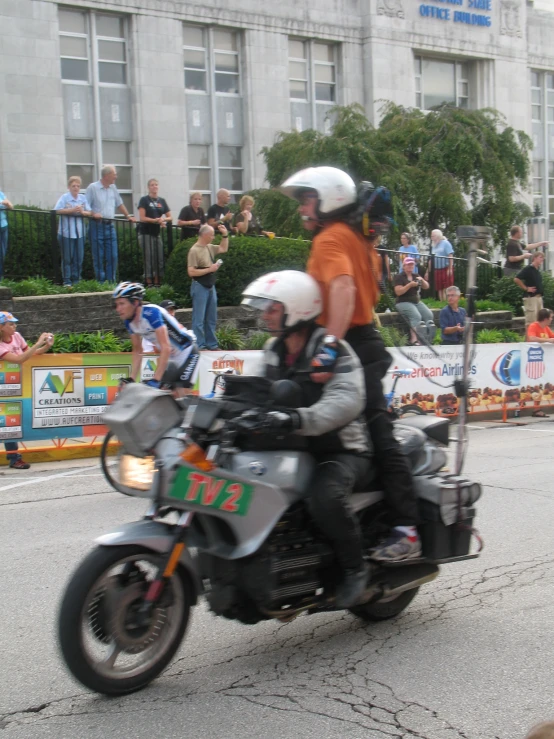 people riding motorcycles down the street in a parade