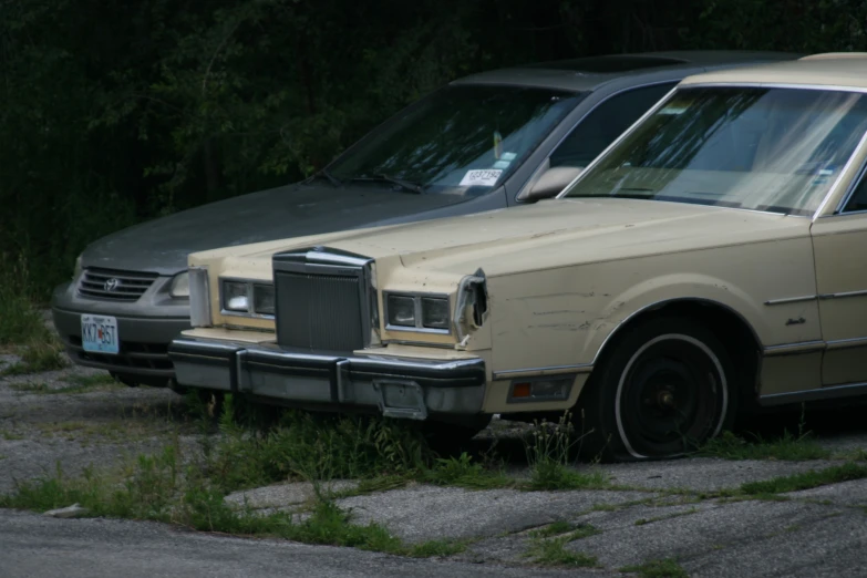 an old car is parked next to a new car