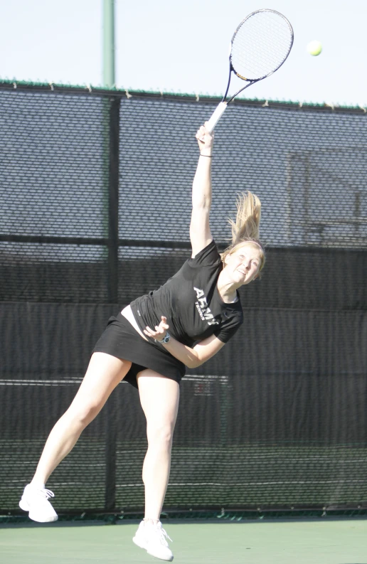 there is a female tennis player playing on the court