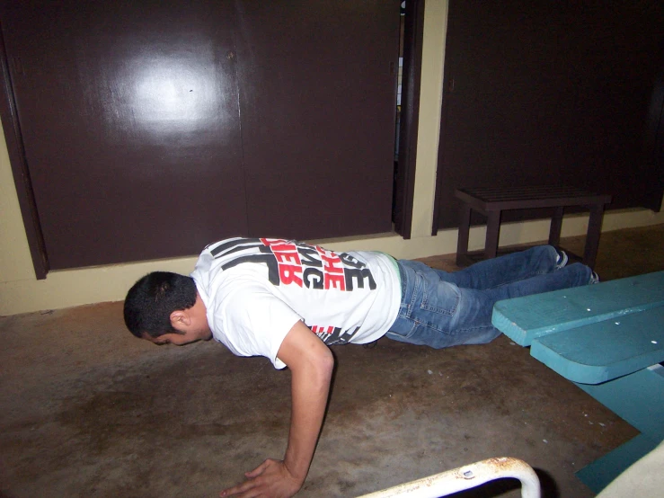 a man is crouched down on the floor with his head down