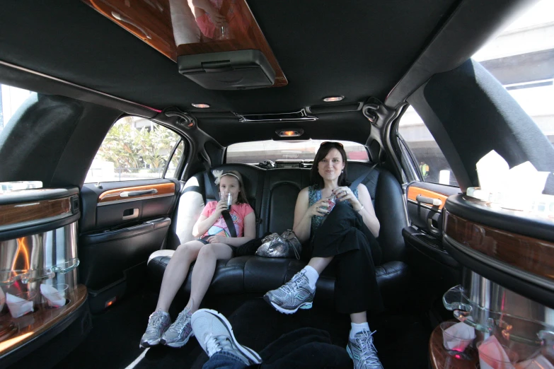 two women sitting in a car and eating