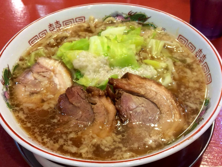 a bowl with meat soup and broccoli in it