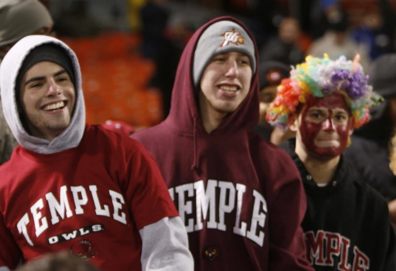 two men are dressed up in their college spirit colors