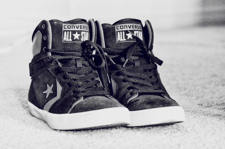 a pair of sneakers that have converse written on them