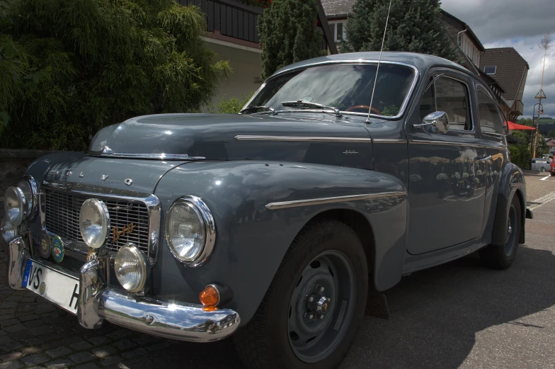 an old car sitting in front of the house