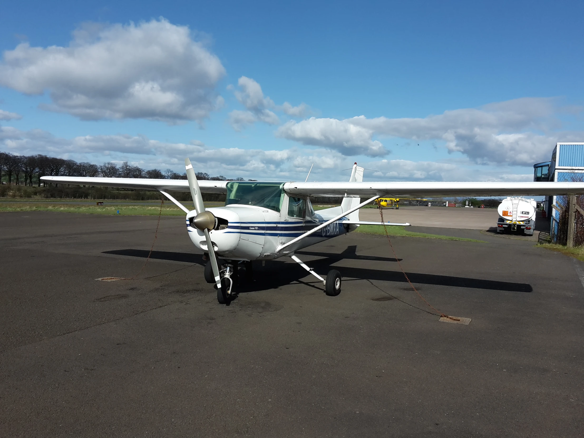 small single engine plane sits parked in a lot