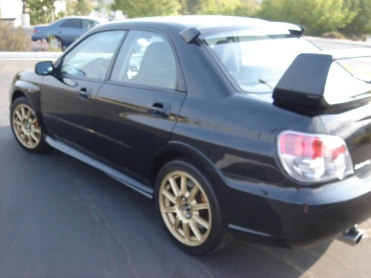 a black subarunt sitting on the side of a road