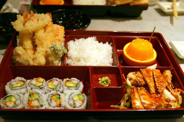 a red tray topped with lots of different sushi