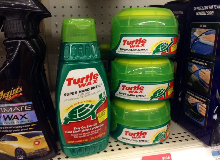 a close up of two bottles of turtle wax on a shelf