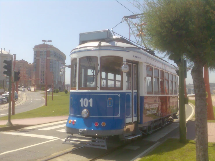 a trolley car is traveling on the road