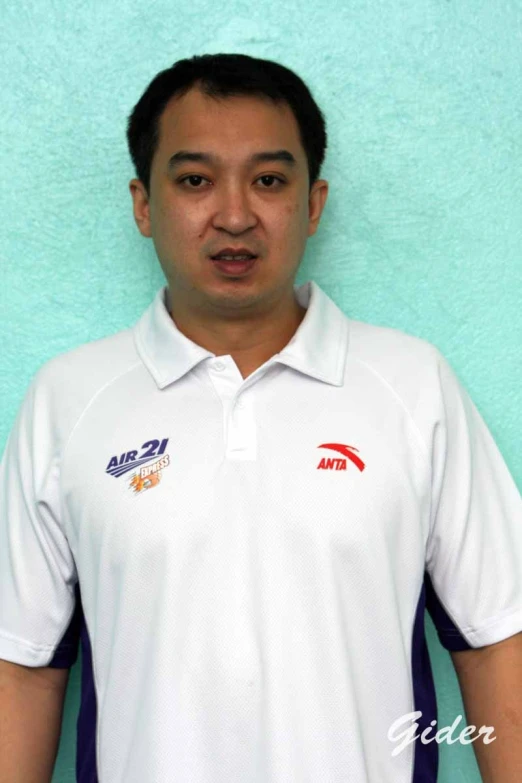 an asian man wearing a white shirt and posing for the camera