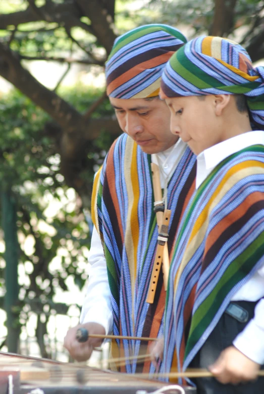 two people with colorful clothes on looking at soing