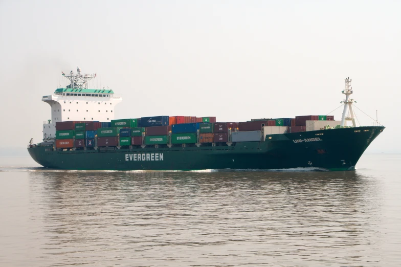 large shipping ship in ocean with cargo on its back