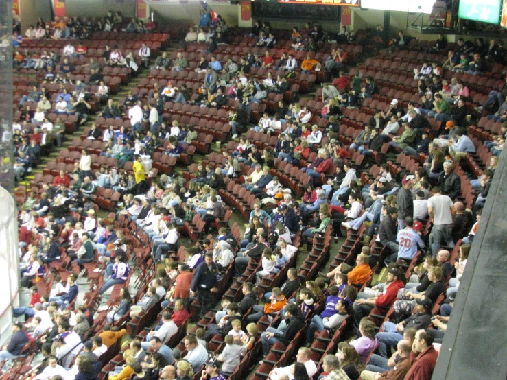 a large crowd of people in an arena with large screen screens