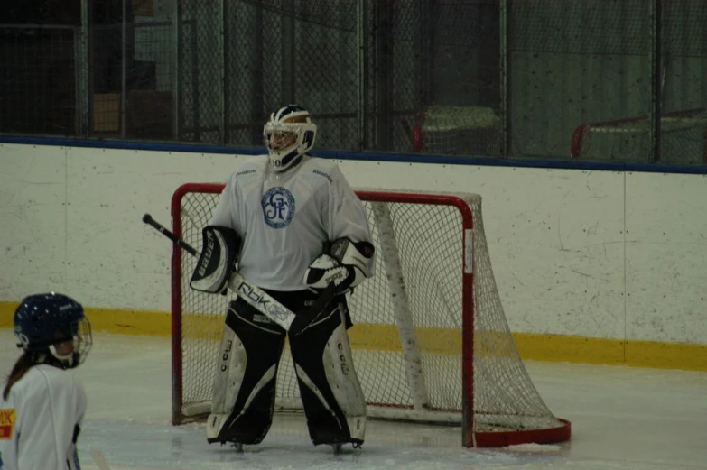 a boy is playing hockey on the ice