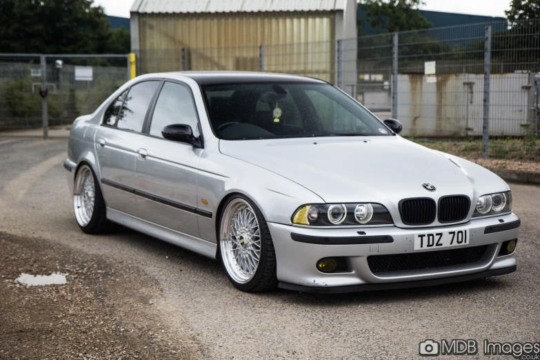 the grey bmw car is parked in the street