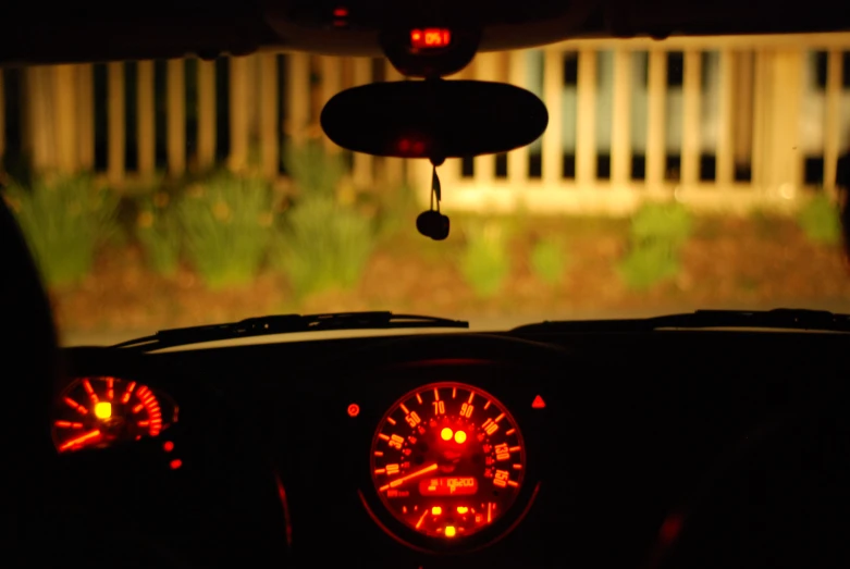 the view from inside of a car that shows a yellow and red gauge in the dashboard