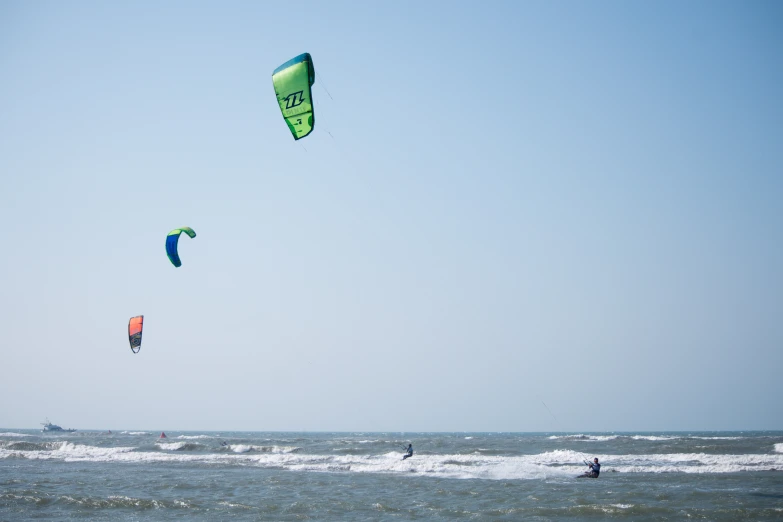 three people para sailing on the ocean waves