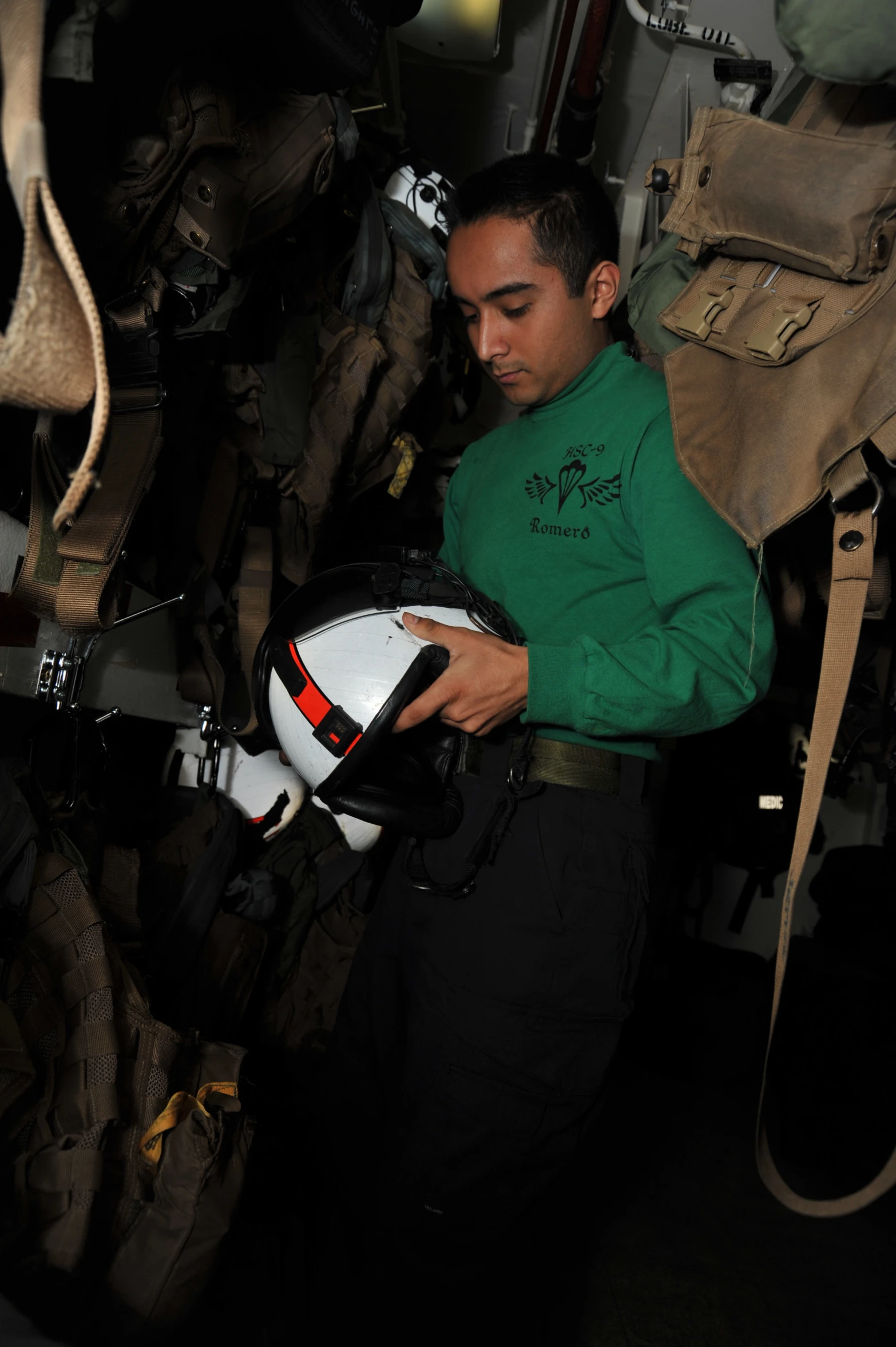 a man in green shirt with helmet working on bike