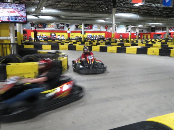 a group of people riding bumper cars down a track