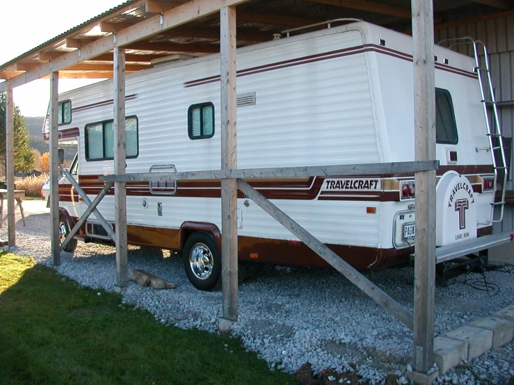 a large trailer is parked under an awning