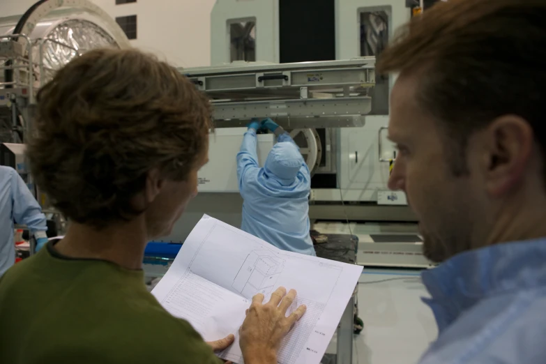 an engineer and a woman working in a factory