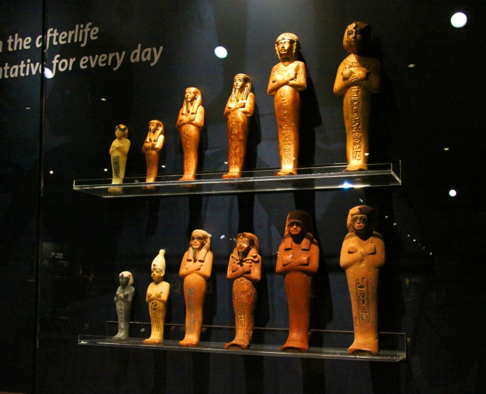 some ancient statues and writing are on shelves