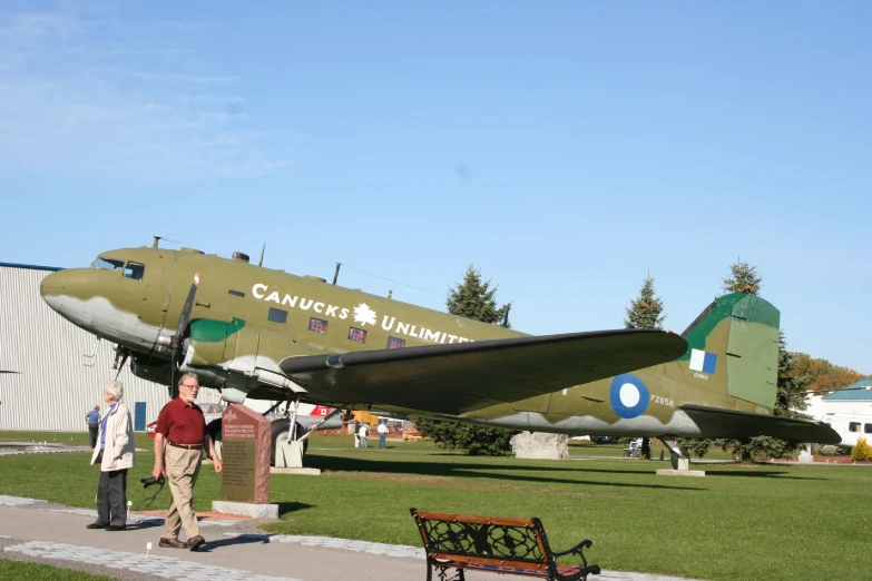 a man walking toward an old fashioned world war ii bomber