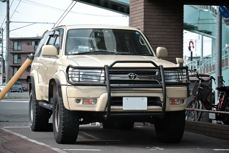 a suv parked in a parking lot next to an office building