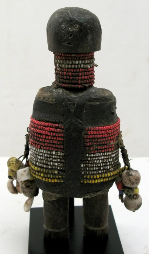 a figurine has been placed with beads