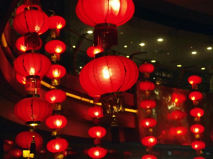 a large display of red lanterns lit up in the dark