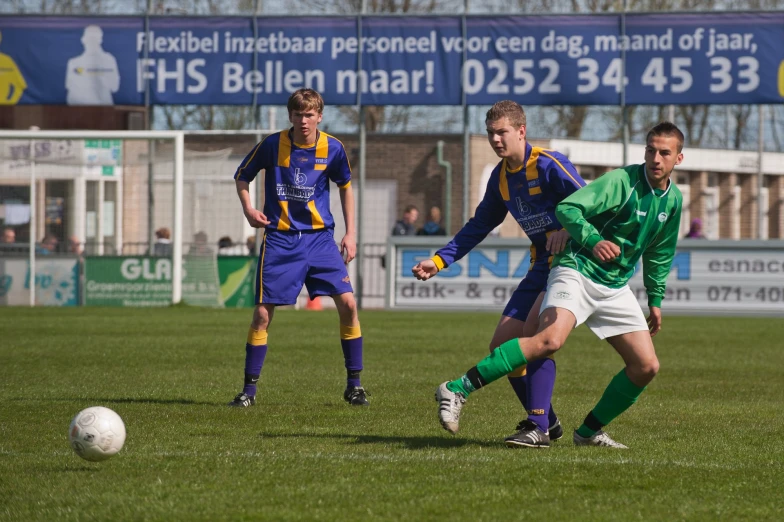 a group of young men playing soccer on a field