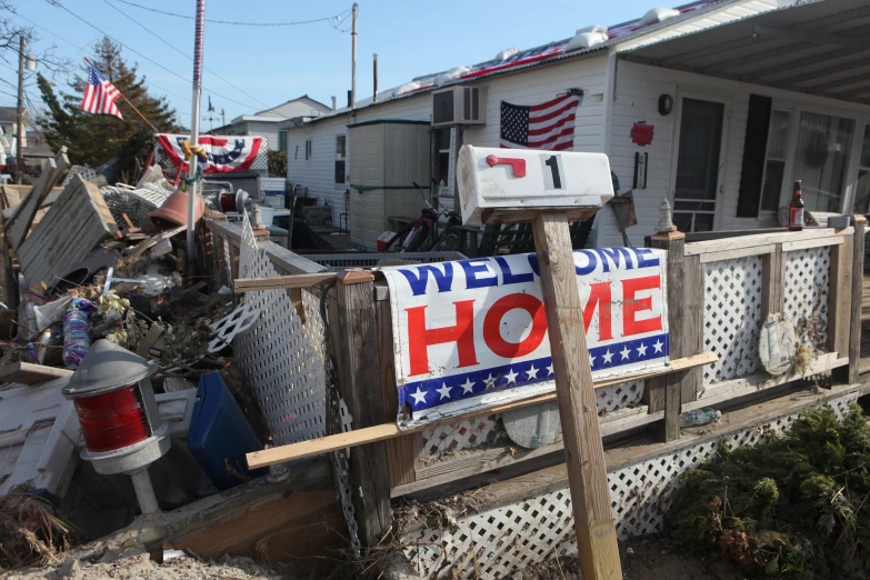 a welcome home sign hanging on the front porch