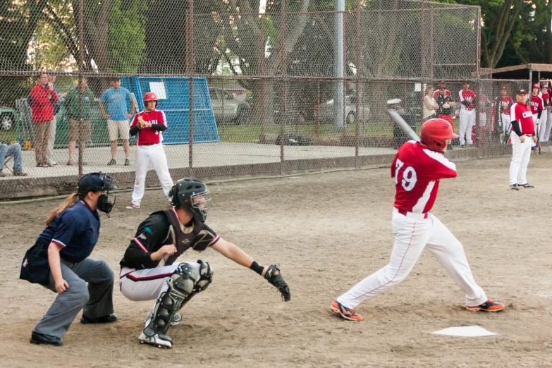 a catcher, umpire and catcher in action on a baseball field