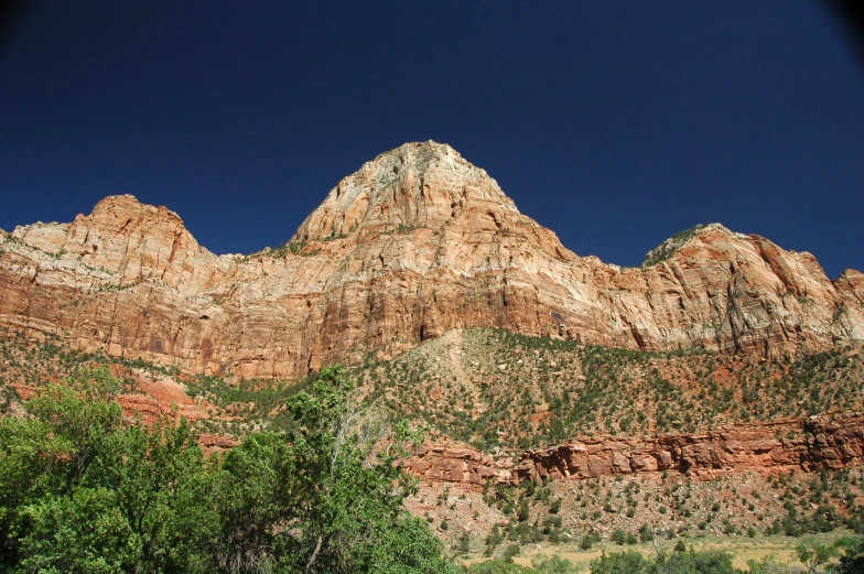 a large mountain is in the distance as seen from the ground