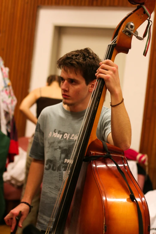 a man holding up a bass on the back of his shoulders