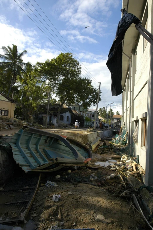 an image of boats in the mud next to building