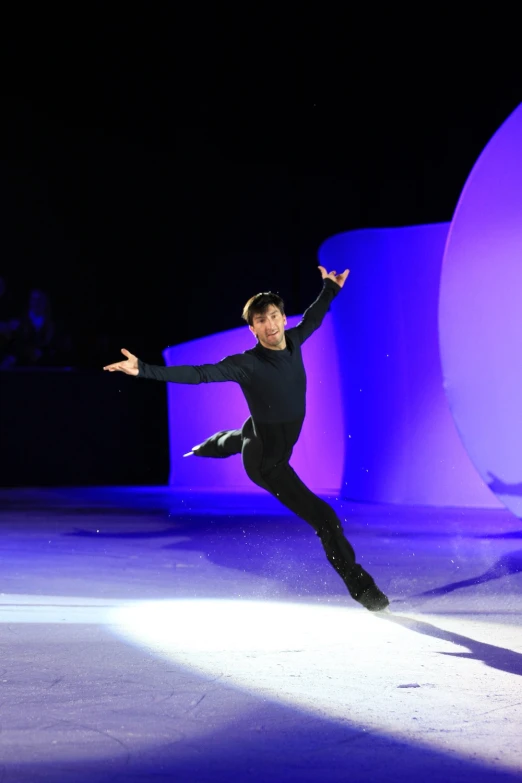 a man with a long sleeve skating on ice