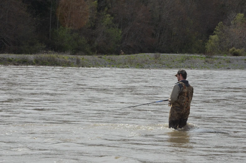 a man is fishing in the water with a boat