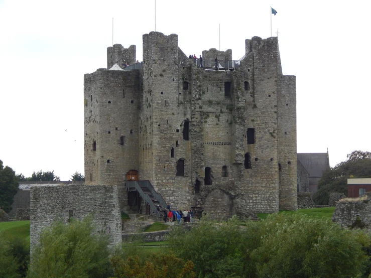 the entrance to a castle like structure with flags sticking out