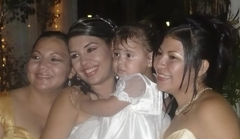 a family poses for a picture as one holds her little girl