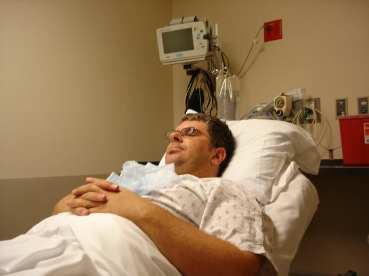 a man in a hospital gown laying down