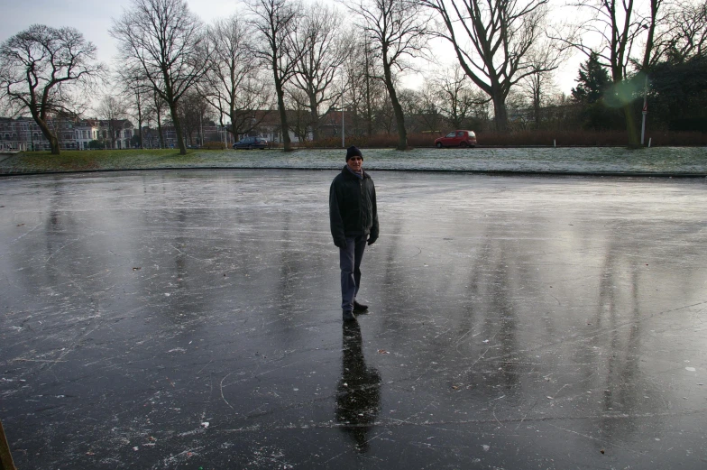 a man standing on top of an ice covered parking lot