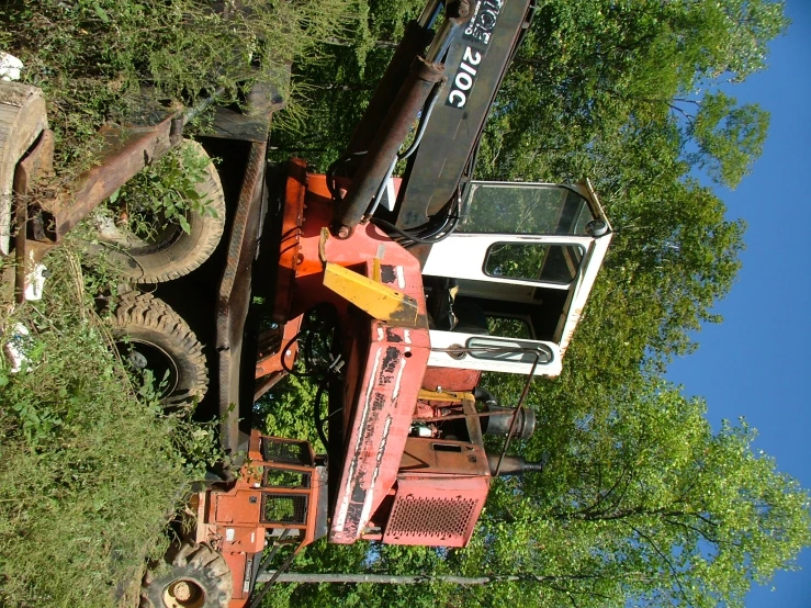 a crane that is in the air next to a vehicle