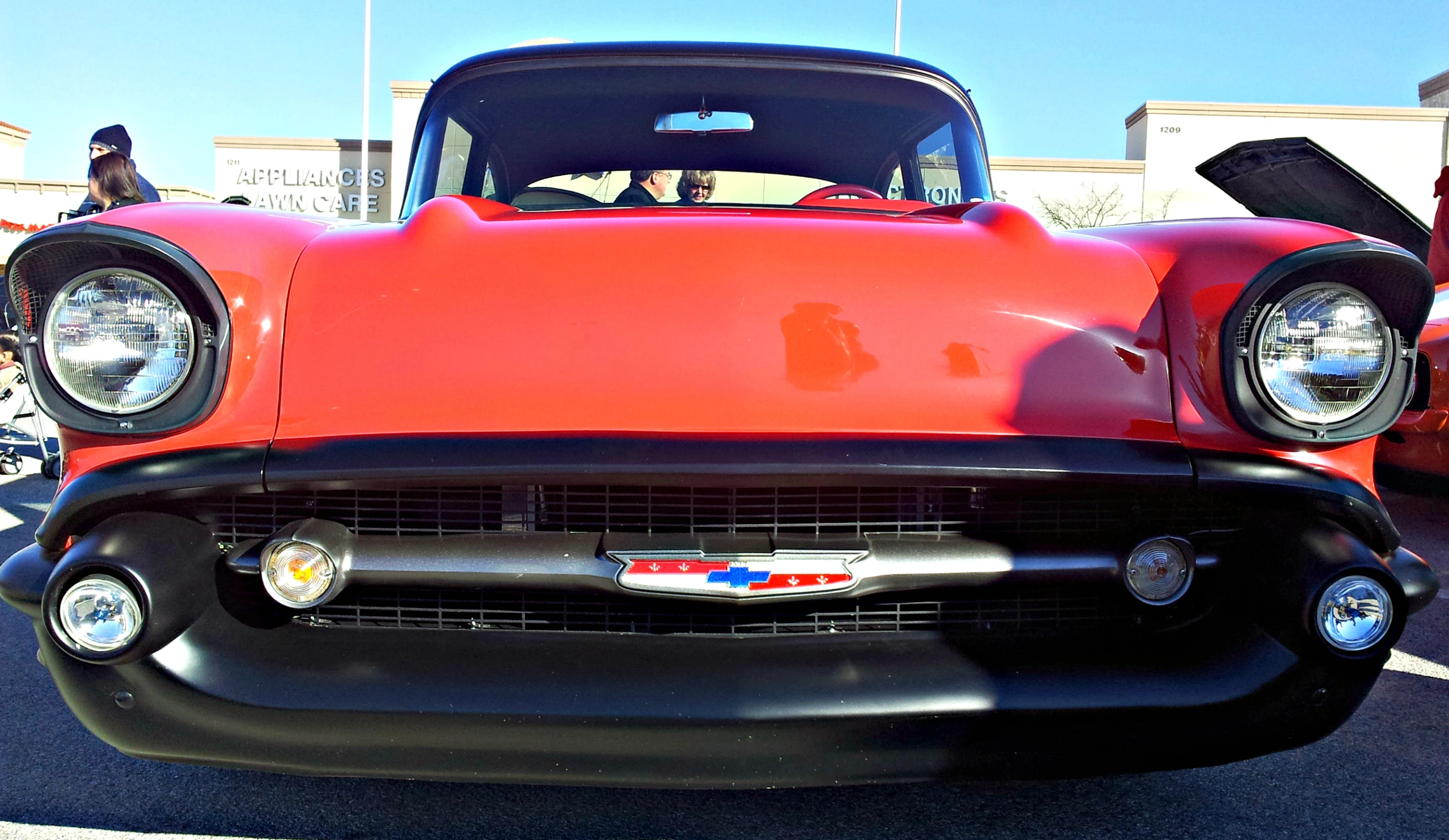 an orange classic truck is shown parked in a lot