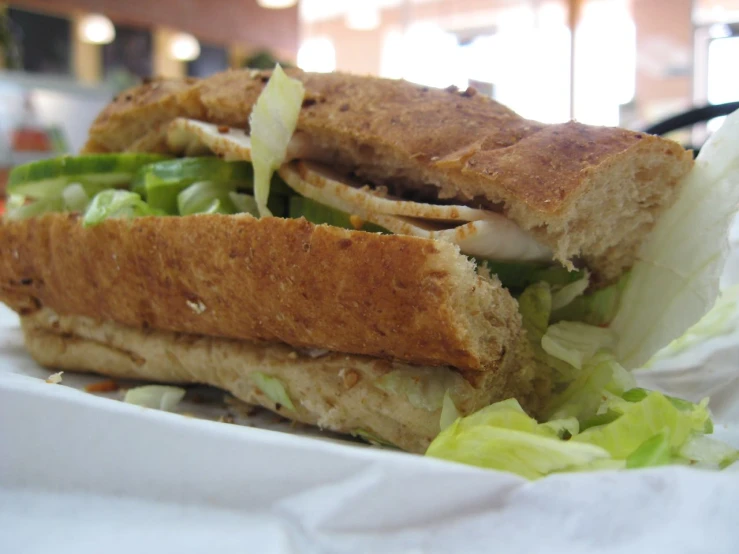 a sandwich on white paper sitting in a container